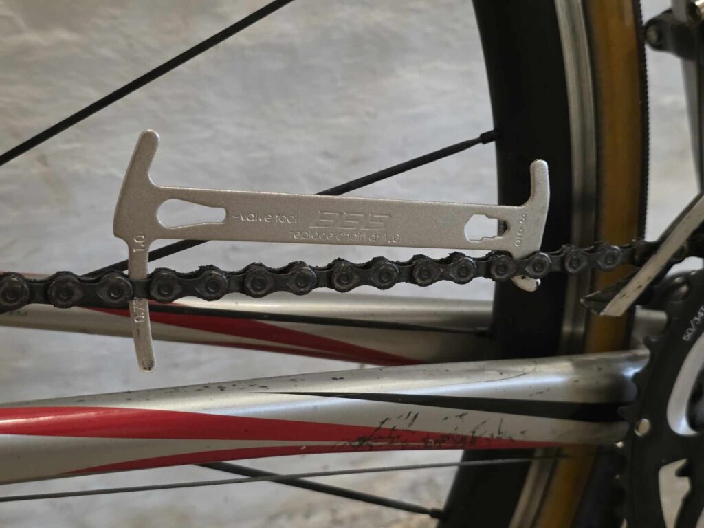 Kædemåler der er sat på en cykelkæde for at måle slid